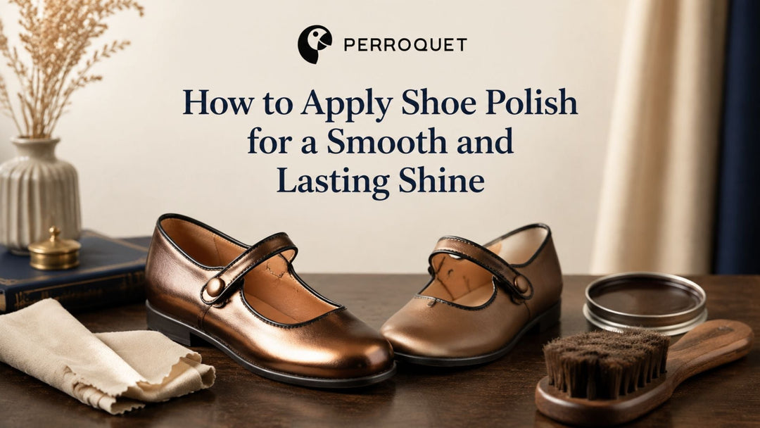 A pair of bronze children’s leather Mary Jane shoes sits on a wooden shoe-care table, with one shoe showing a brighter polished shine.